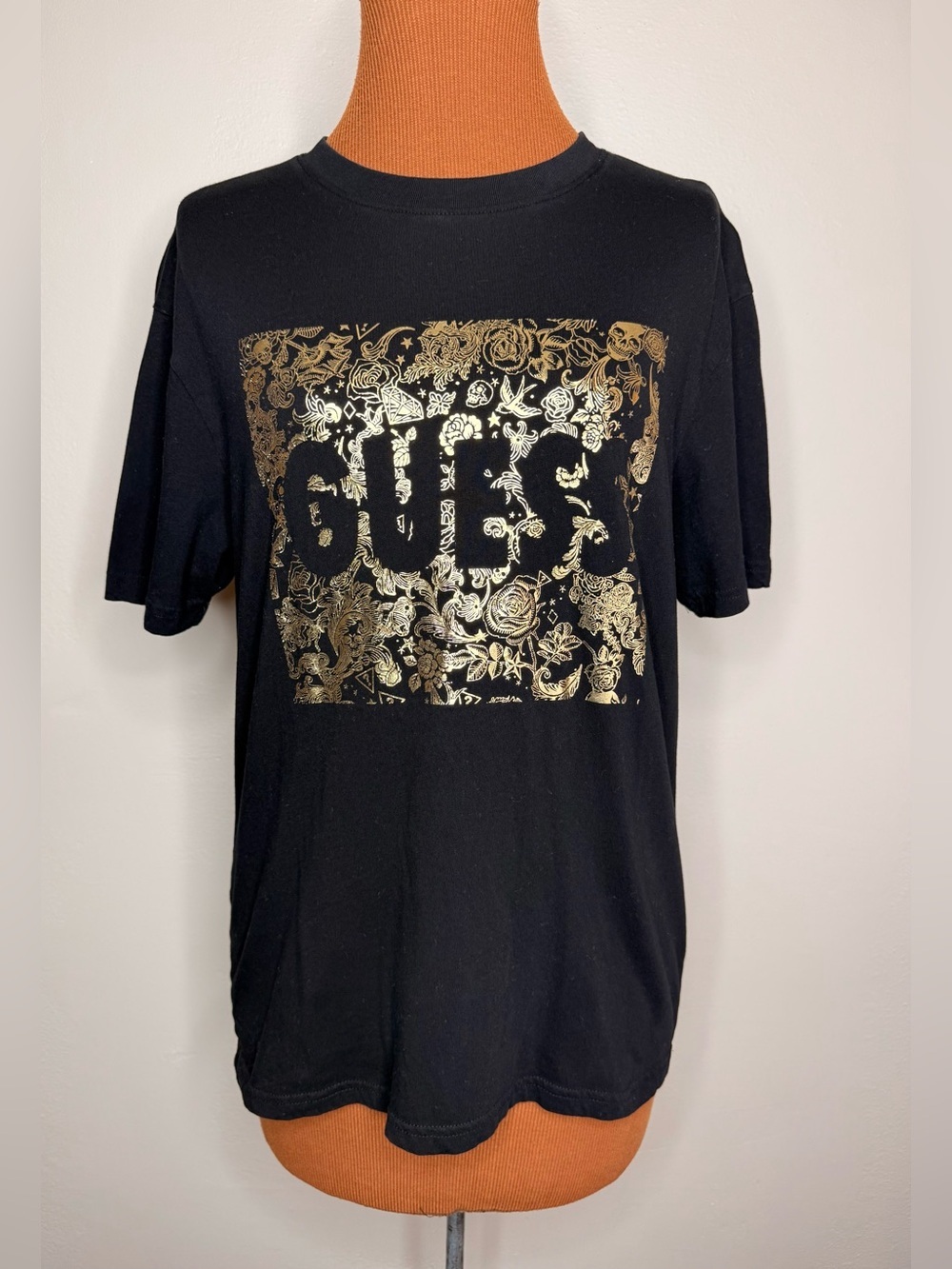GUESS Black Tee with Metallic Gold Floral Logo Size Medium